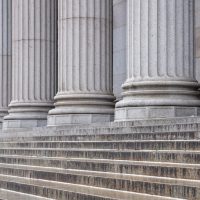 Stone pillars row and stairs detail. Classical building facade